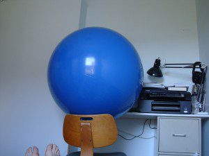 A person's feet on a chair.