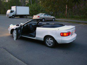 A white car parked in a parking lot.