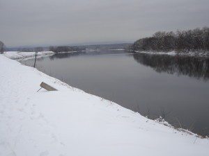 A river with snow on the ground.