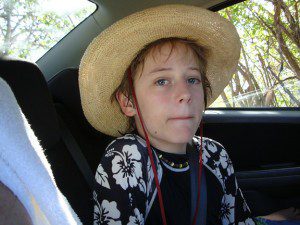 A young boy wearing a straw hat.