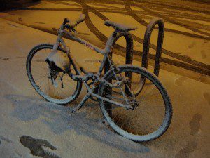 A New York bike is covered in snow.