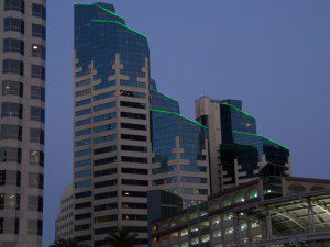 A tall building with green lights.