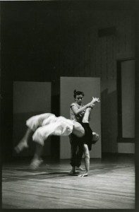 A black and white photo of two dancers performing on a stage.