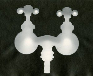 A black and white image of two faucets on a black background.