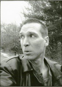 Black and white photo of a man in a leather jacket.