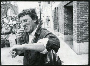 A man talking on a cell phone in front of a building.