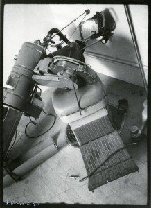 A black and white photo of a machine on the floor.