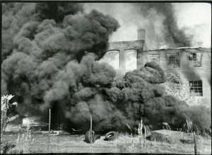 A black smoke billows out of a building.