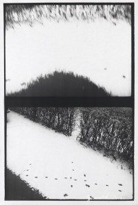 A black and white photograph of a snow covered area.