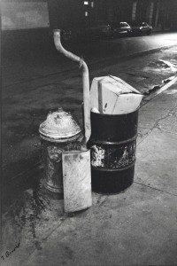 A black and white photo of a fire hydrant on the sidewalk.