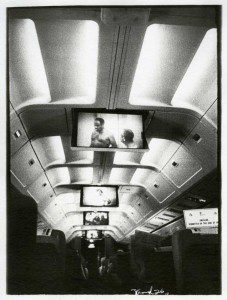 A black and white photo of an airplane with televisions.