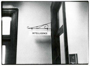 A black and white photo of a sign that says intelligence.