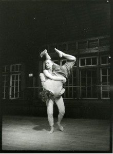 A black and white photo of two people performing a dance.