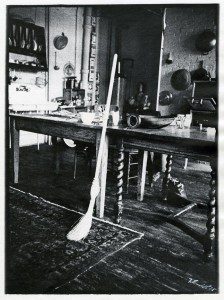An old black and white photo of a table with a long stick in it.