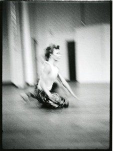 A black and white photo of a dancer on the floor.