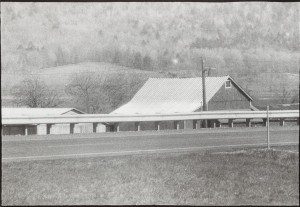 An old black and white photo of a barn.