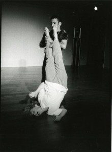 Performer balancing inverted on partner's hands