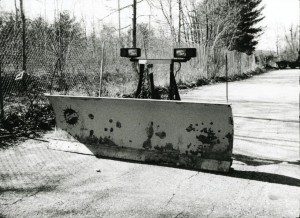 A black and white photo of a snow plow on a road.