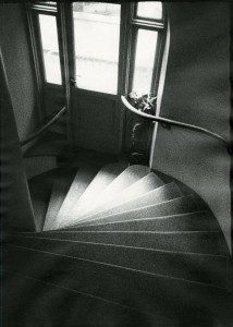 A black and white photo of a spiral staircase.