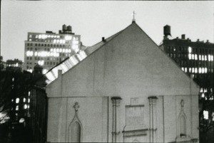 A black and white photo of a church at night.