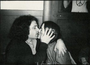 An old photo of a man kissing a woman.