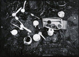 A black and white photo of a table with cups and spoons on it.