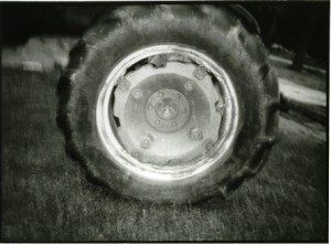A black and white photograph of a tractor tire.