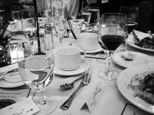 A black and white photo of a dinner table.