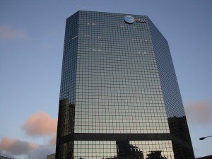 Glass AT&T skyscraper reflecting evening clouds